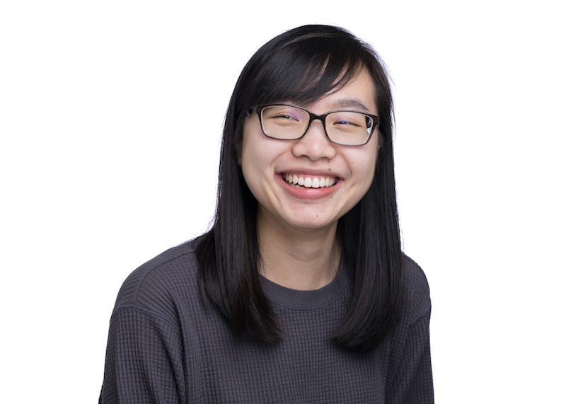 Kelsey, an Asian woman smiling and wearing rectangular glasses